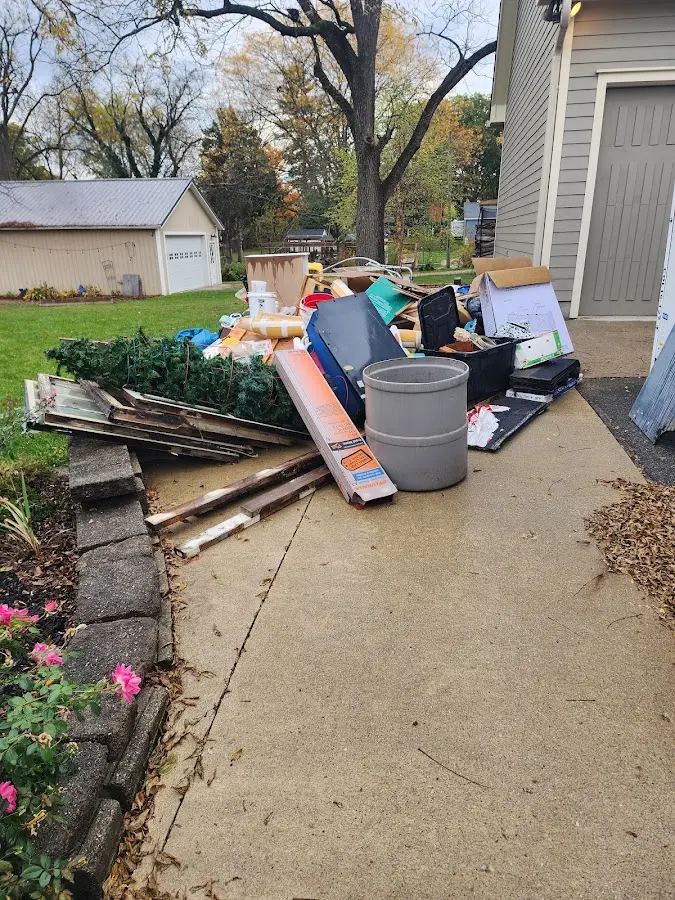 Dumpster being loaded with debris for 12 Yard Dumpster Rental in Oglesby